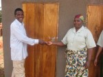 John Shekuamba handing over dispensary toilet keys to&nbsp;nurse