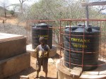 Kwembalazi Primary School – Boy in front of two SIM&nbsp;tanks